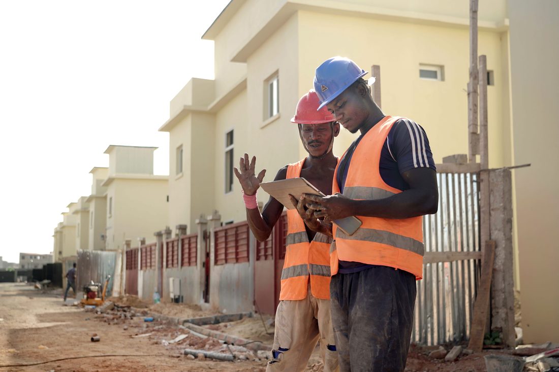 Site team reviewing plans on a tablet on an Accra build